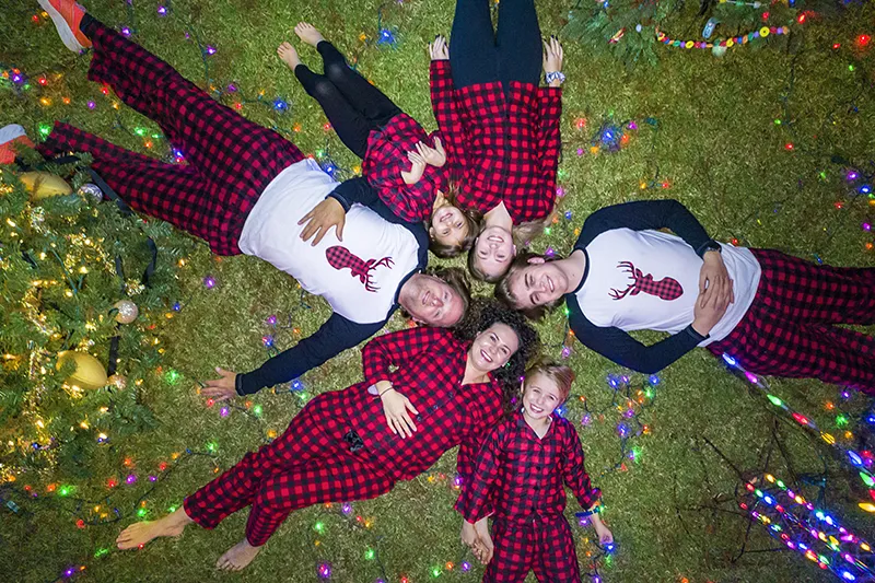 people in Christmas pajamas laying in circle