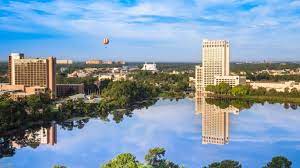 Lake Buena Vista, Florida's skyline. A yellow and orange hot air balloon is visible in the sky over the area. Lake Buena Vista, Florida is a location served by Johannessen Lights.
