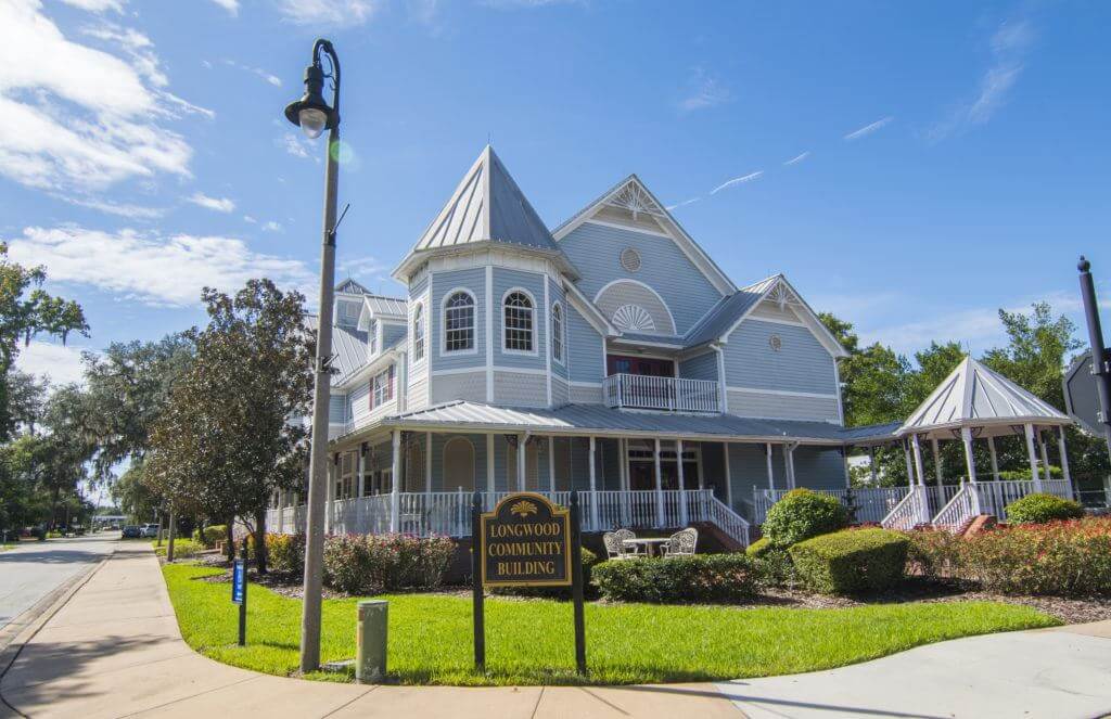 The Longwood Community Building in Longwood, Florida. A Victorian style building with a wraparound porch. Longwood, Florida is a location served by Johannessen Lights. 