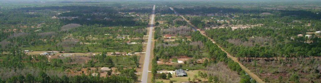 An aerial view of a rural road in Wedgefield, Florida. Wedgefield, Florida is a location served by Johannessen Lights.